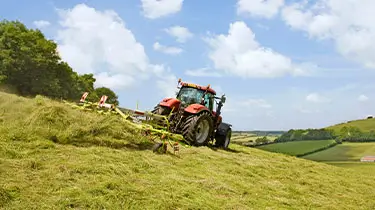 Baler in field making bales