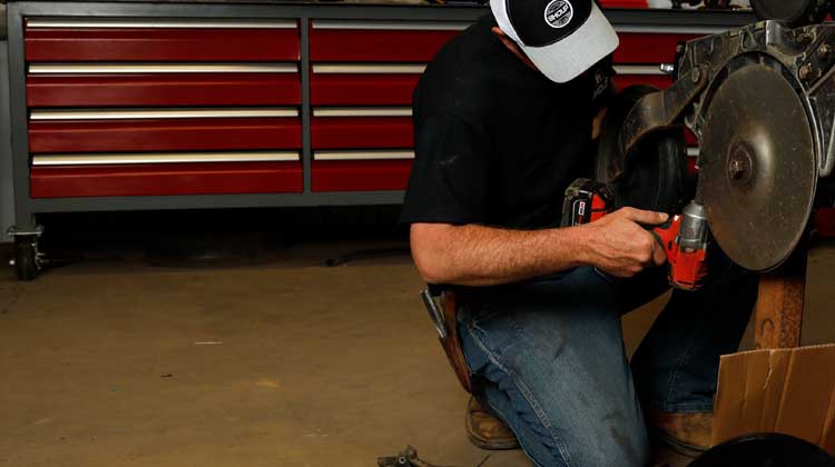 Man working on machine in garage