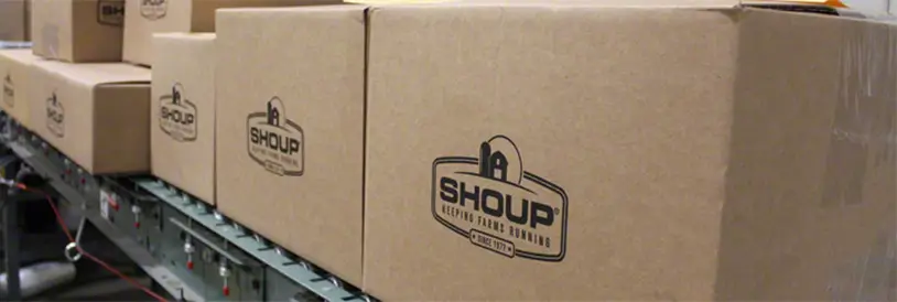Shoup branded shipping boxes on a conveyor belt